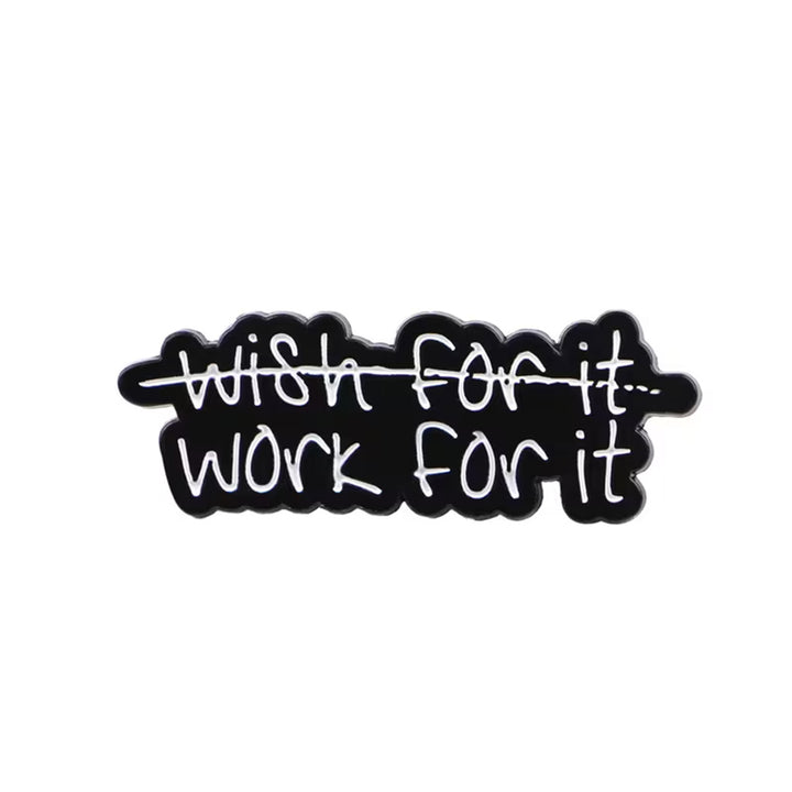 Black and white motivational pin badge with &