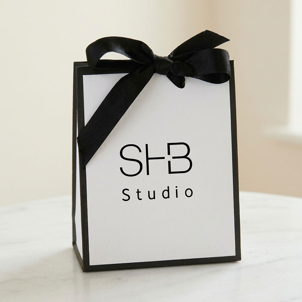 SHB Studio white gift bag with black satin ribbon bow – every jewellery order arrives gift-ready with a free message card
