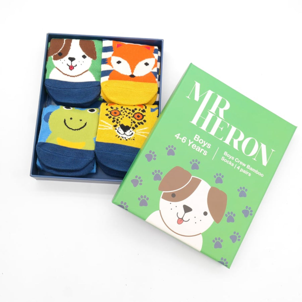Set of children's socks with animal designs in a box, next to a green packaging box with 'MR HERON' branding.