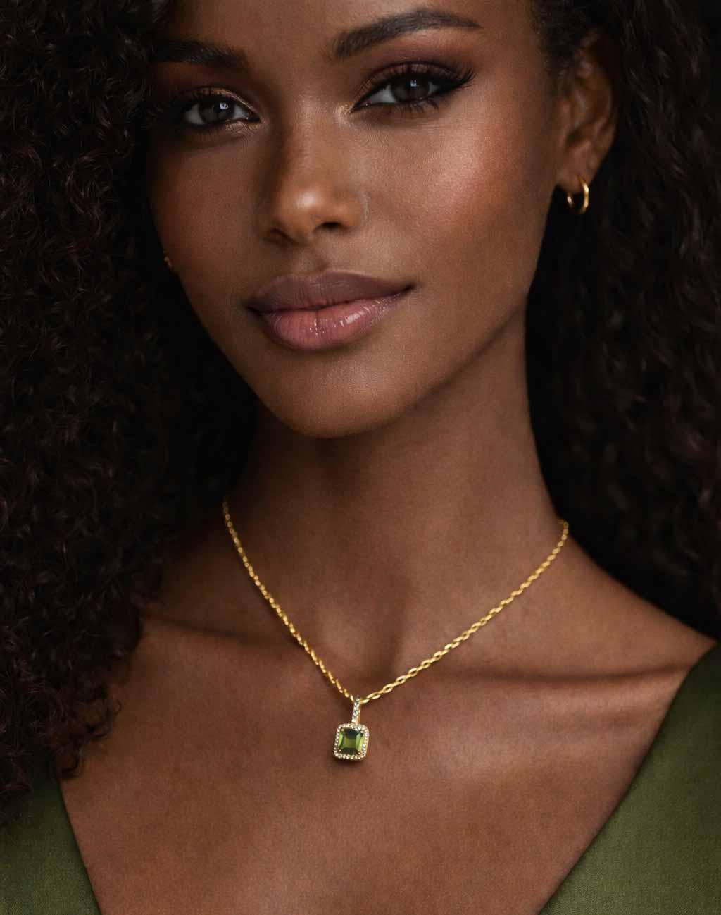 model wearing green zirconia stainless steel necklace with gold chain.