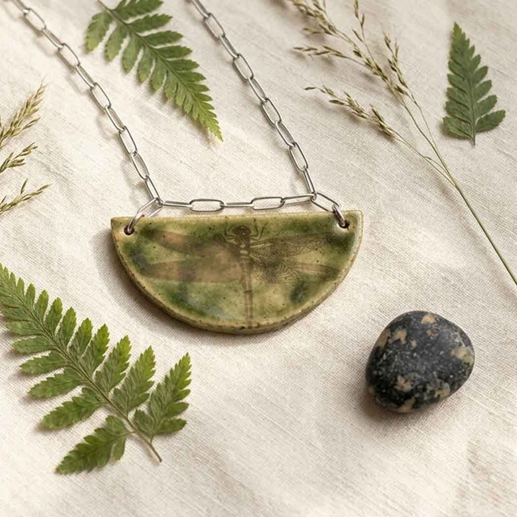 Handmade half-moon ceramic pendant necklace with a vintage dragonfly , on a stainless steel paperclip chain.