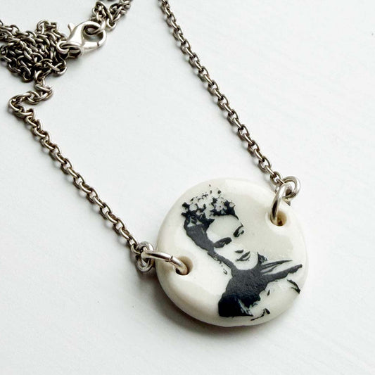 Necklace with a pendant featuring Frida Kahlo Mexican painter white background