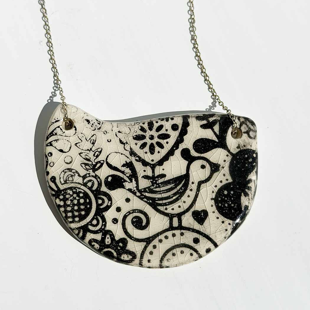 bird and flower motif ceramic half moon necklacce