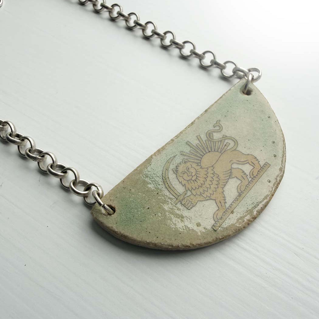 lion and sun persian symbol on half moon ceramic light green necklace 1