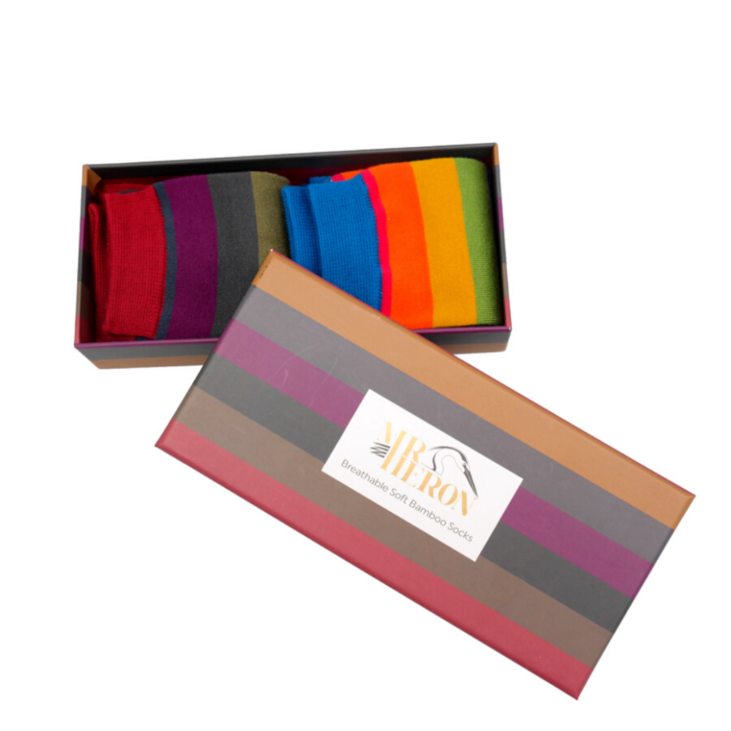Colorful striped socks in an open box with a visible brand logo on a white background