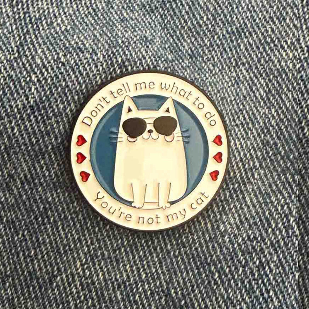 cat pin badge on jeans fabric