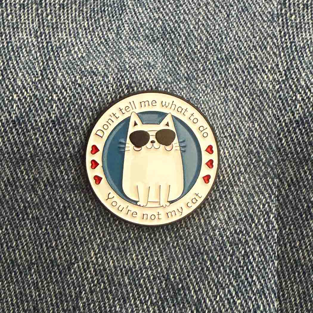cat pin badge on jeans fabric