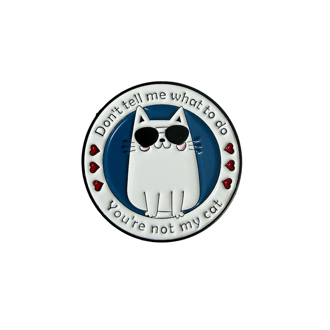 A circular enamel pin featuring a white cartoon cat wearing black sunglasses, with the text &