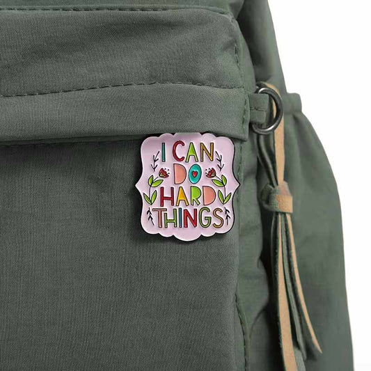 I can do hard things pin badge on bag.