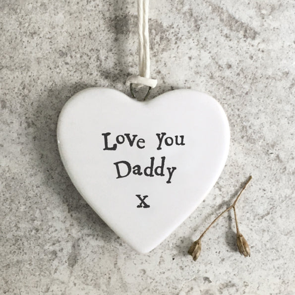 Heart-shaped white plaque with 'Love You Daddy X' text on a textured surface