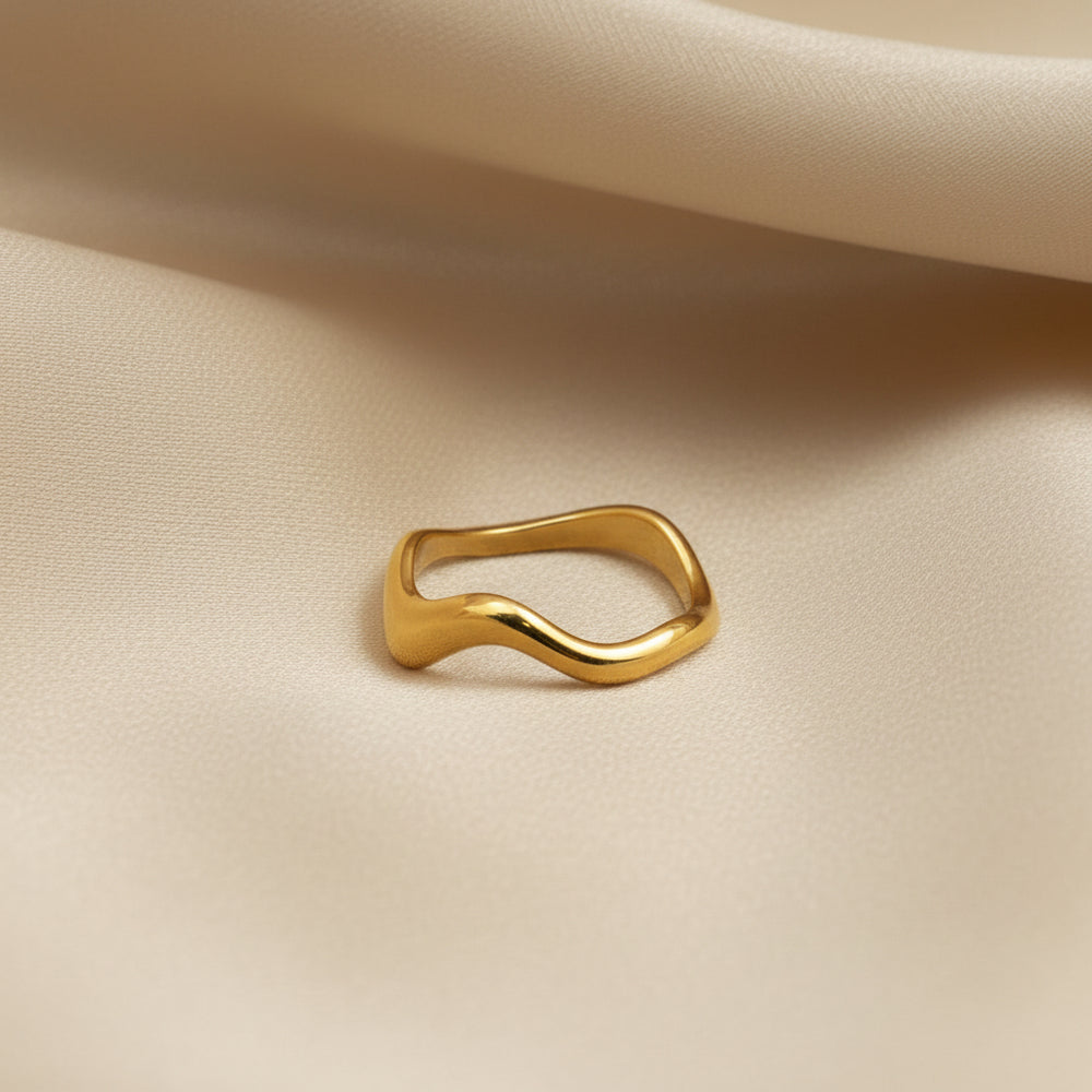 Gold ring on a beige fabric background