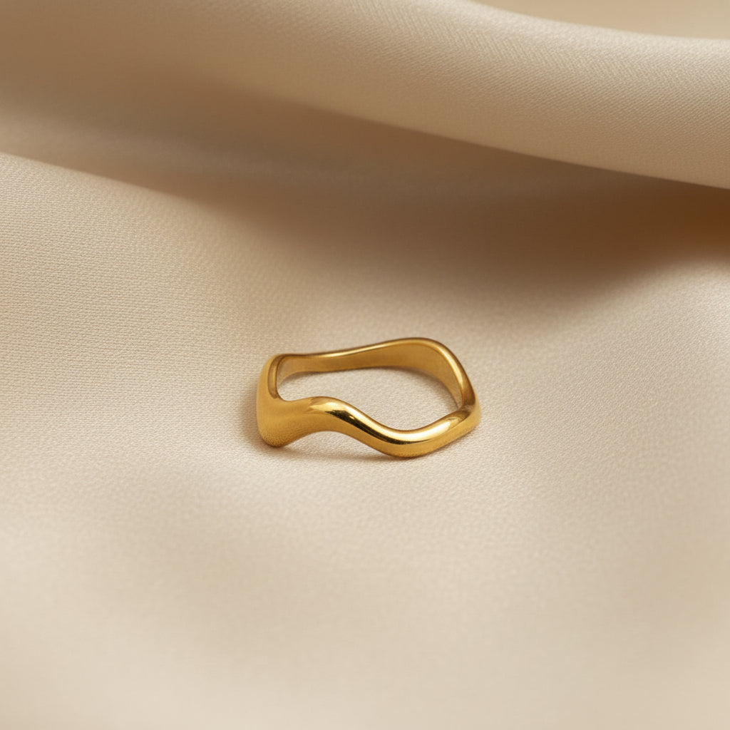 Gold ring on a beige fabric background