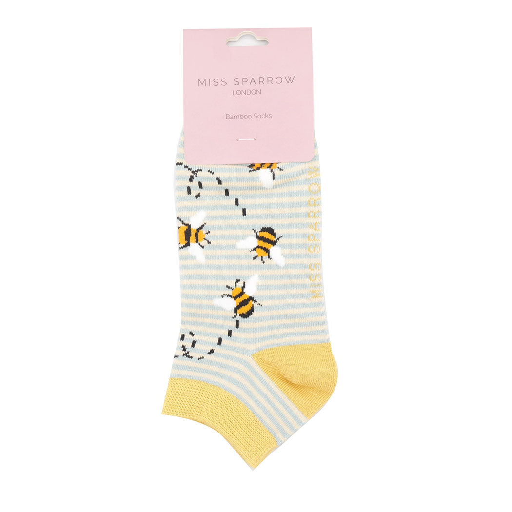 Packaged socks with bee pattern and yellow accents on a white background