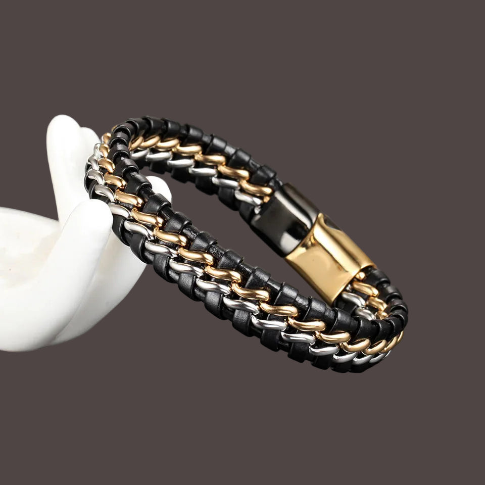 Black, gold, and silver braided bracelet on a dark surface