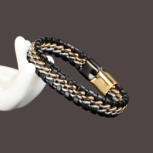 Black, gold, and silver braided bracelet on a dark surface