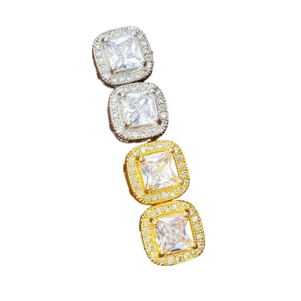 Pair of gold and silver square-cut gemstone earrings in a wooden box.