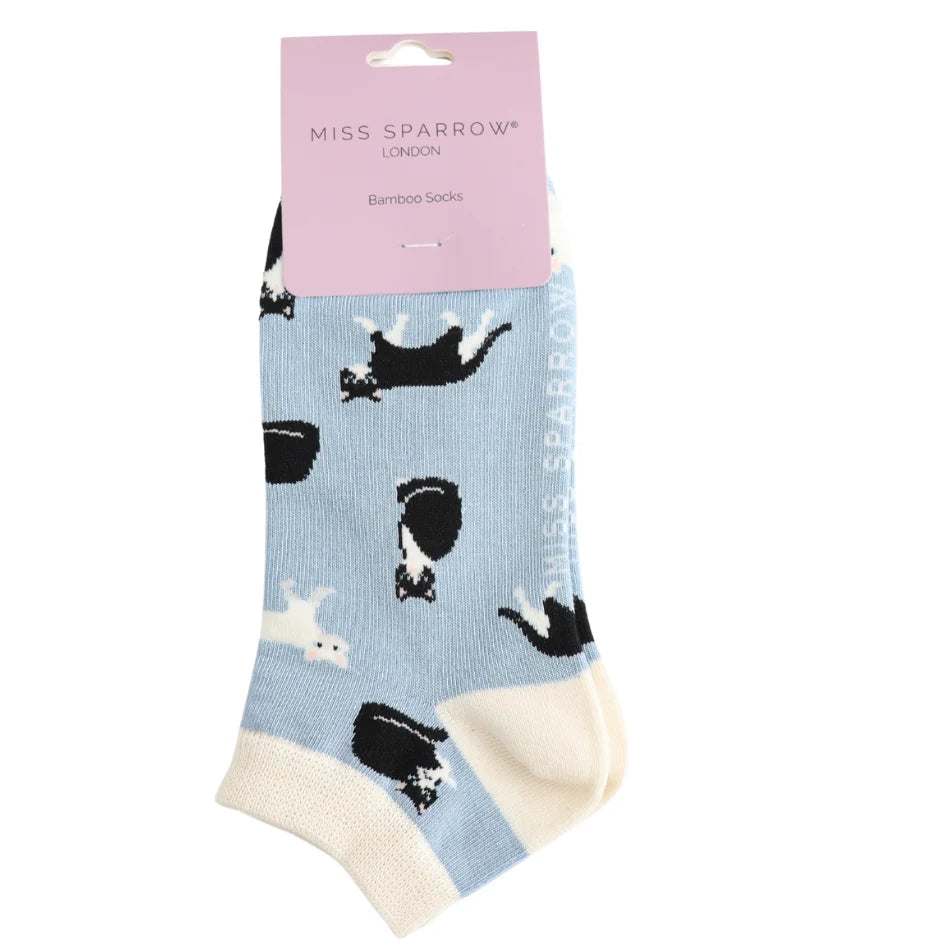 Pair of socks with cat pattern and 'Miss Sparrow' packaging on a white background