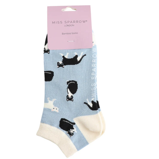 Pair of socks with cat pattern and 'Miss Sparrow' packaging on a white background