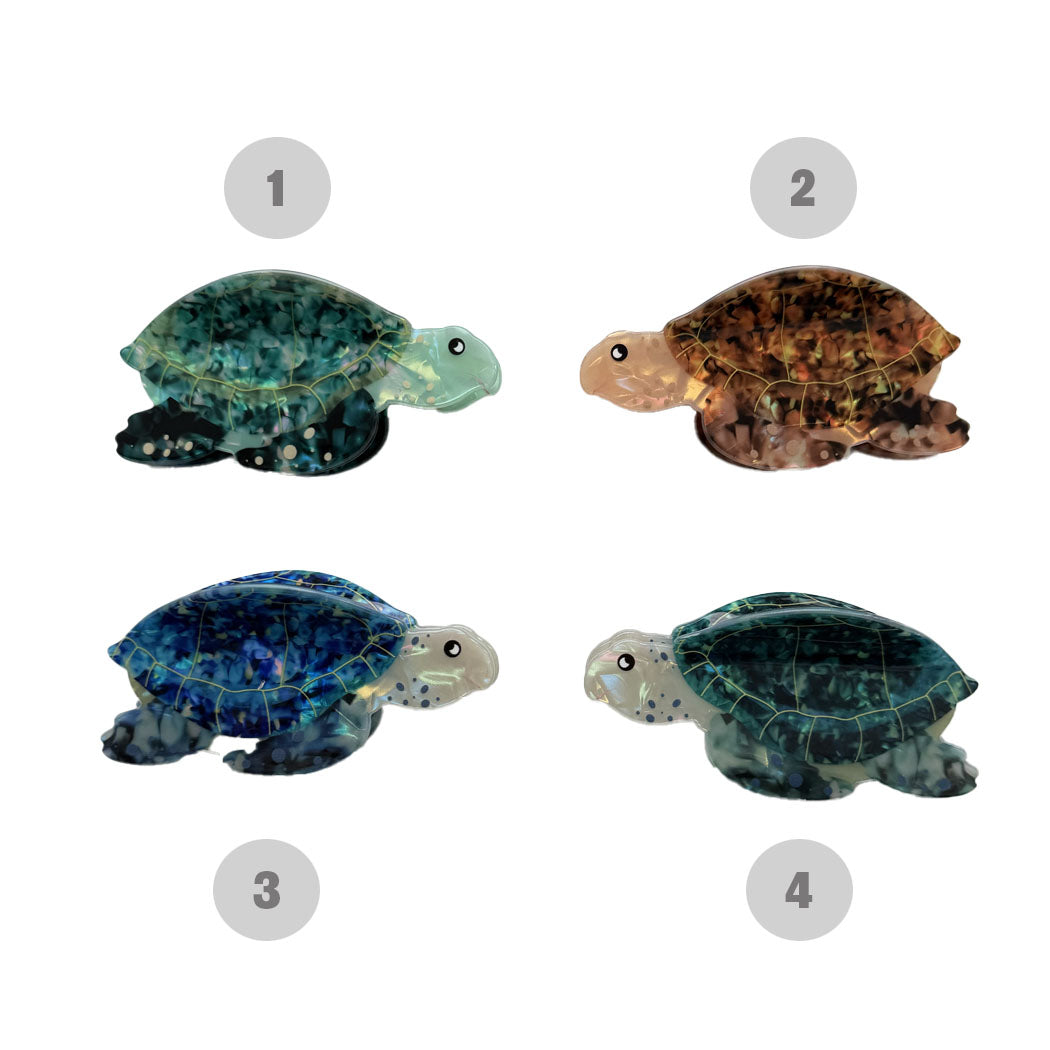 Four turtle figurines with different color patterns on a white background