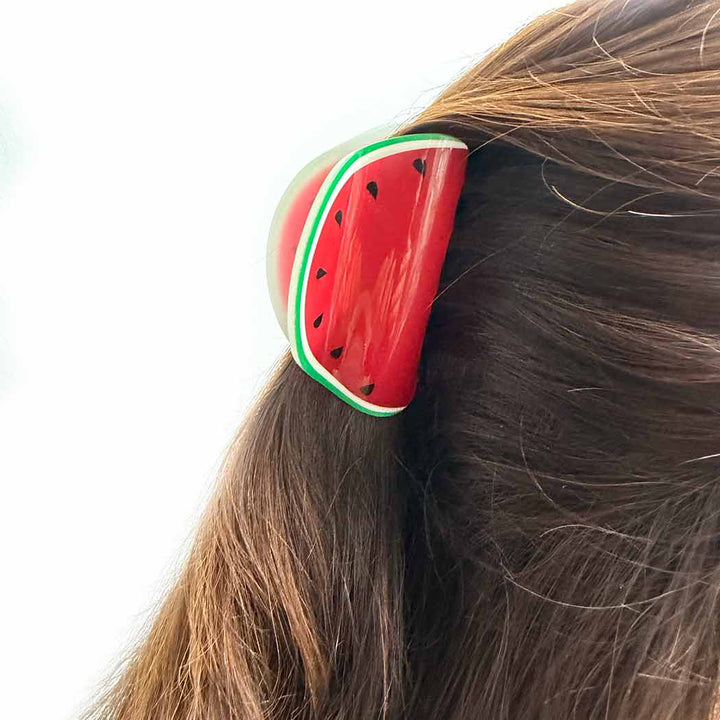 Watermelon-themed hair clip on a person&