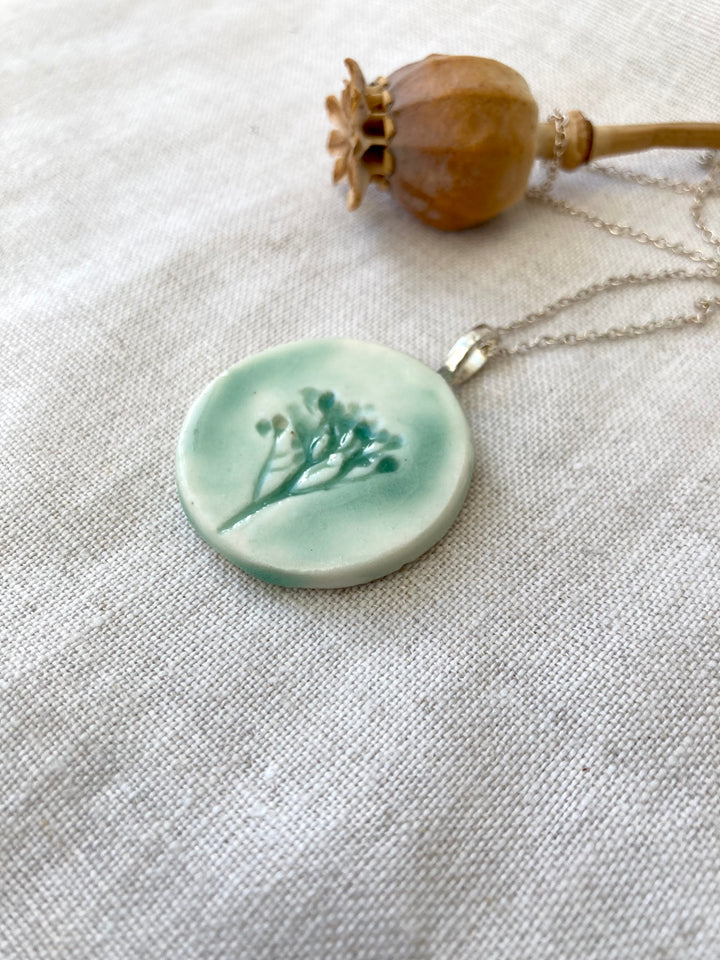 Embossed floral ceramic necklace piece