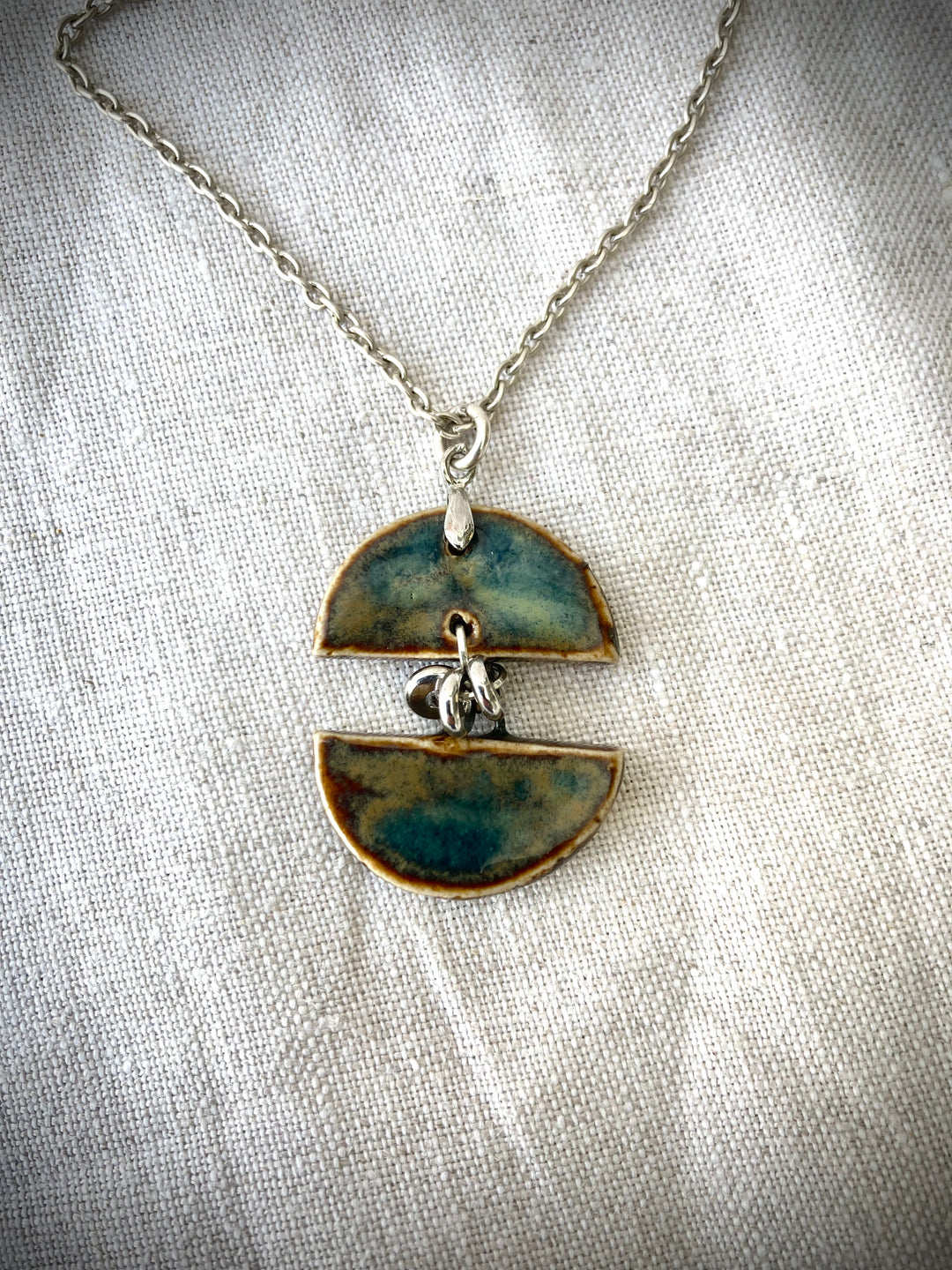 Half-moon ceramic pendant on silver chain